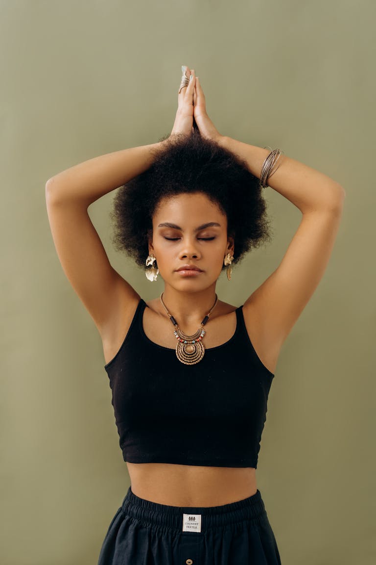 A woman in a yoga pose with closed eyes, symbolizing tranquility and self-awareness.