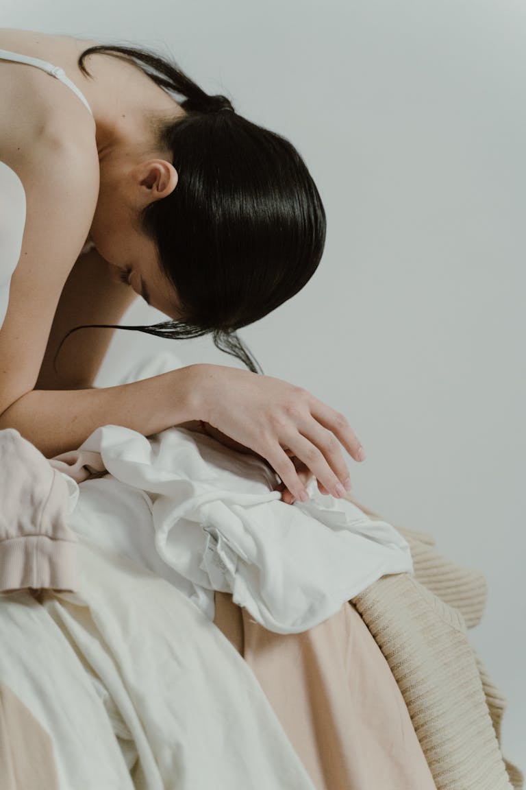 Close-up of a woman resting her head on her arms, exuding calm and introspection.