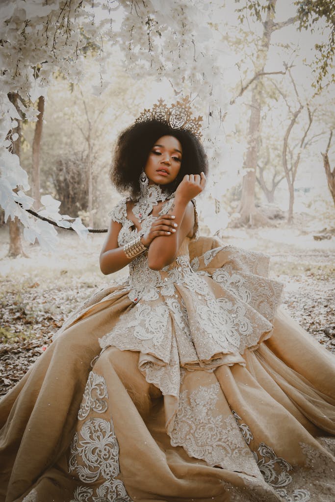 A beautiful bride in an ornate gown posing gracefully in a forest scene, exuding elegance.