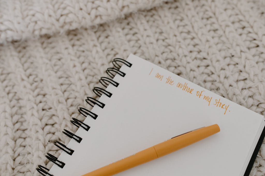 Notebook with motivational text on wool blanket, ideal for cozy home office setups.